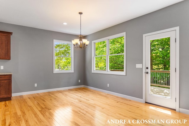 17946 Robbins Rd, Grand Haven, MI 49417 - unfurnished dining area with light wood-style flooring, baseboards, a chandelier, and recessed lighting