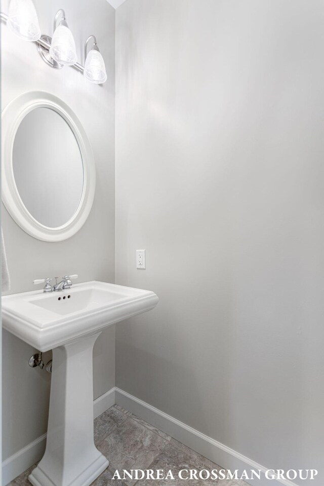 17946 Robbins Rd, Grand Haven, MI 49417 - bathroom featuring baseboards and a sink