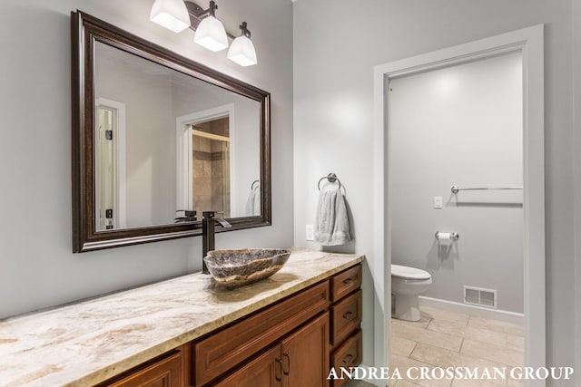 17946 Robbins Rd, Grand Haven, MI 49417 - full bathroom featuring vanity, toilet, baseboards, and a shower
