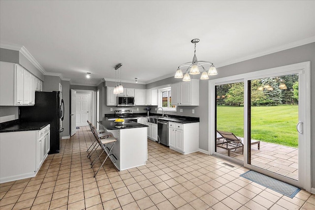 4047 Ramsgate Ct, Ann Arbor, MI 48103 - kitchen with stainless steel appliances, dark countertops, a chandelier, white cabinetry, and crown molding