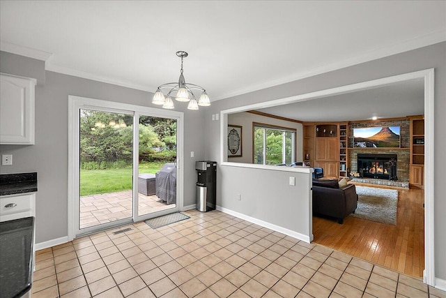 4047 Ramsgate Ct, Ann Arbor, MI 48103 - kitchen featuring plenty of natural light, a chandelier, ornamental molding, and white cabinets