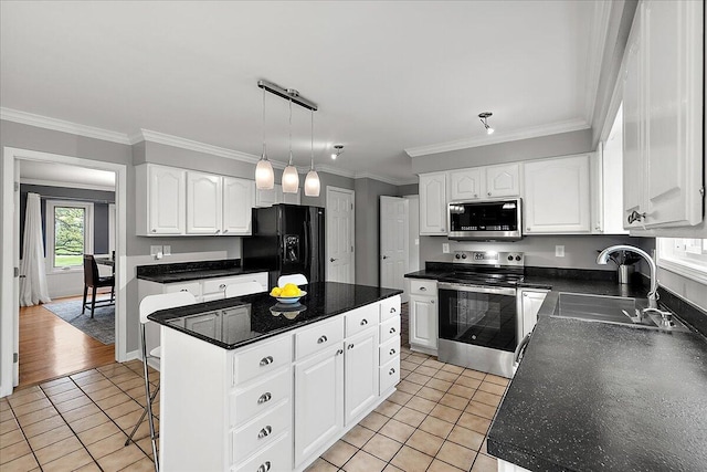 4047 Ramsgate Ct, Ann Arbor, MI 48103 - kitchen with stainless steel appliances, a sink, dark countertops, light tile patterned floors, and a kitchen island
