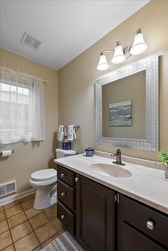 4047 Ramsgate Ct, Ann Arbor, MI 48103 - bathroom with vanity, toilet, tile patterned flooring, and baseboards