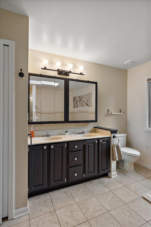 4047 Ramsgate Ct, Ann Arbor, MI 48103 - full bath with double vanity, tile patterned flooring, baseboards, and toilet