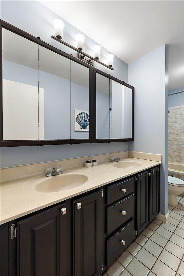 4047 Ramsgate Ct, Ann Arbor, MI 48103 - full bath with double vanity, toilet, tile patterned floors, and a tub to relax in