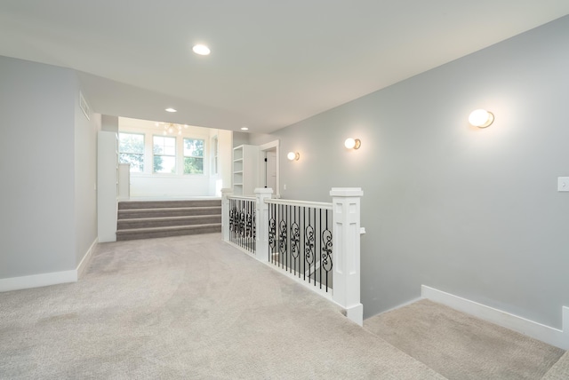 6606 Spaniel Dr, Kalamazoo, MI 49009 - hallway featuring carpet floors, baseboards, an upstairs landing, and recessed lighting