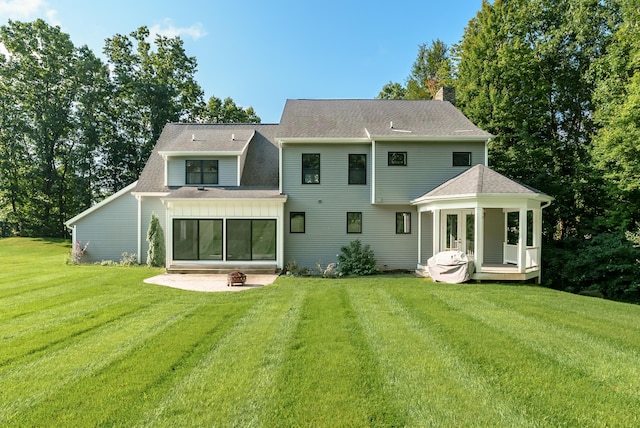 6606 Spaniel Dr, Kalamazoo, MI 49009 - rear view of property with a lawn, a patio area, a deck, a shingled roof, and a chimney