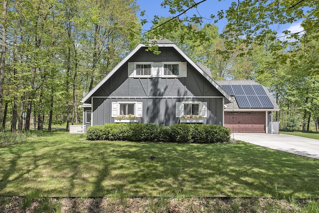 9787 Center Ln, Canadian Lakes, MI 49346 - view of front of home with driveway, a garage, a front yard, and solar panels