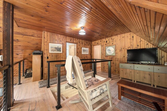 9787 Center Ln, Canadian Lakes, MI 49346 - living room featuring wood walls, lofted ceiling, wooden ceiling, and wood-type flooring