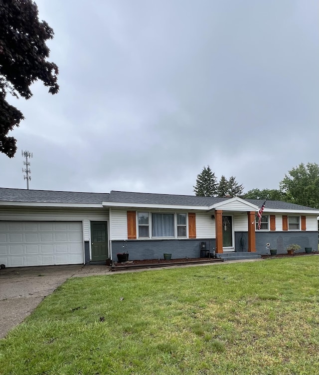 7095 Westwood Dr, Jenison, MI 49428 - ranch-style house with driveway, a garage, a front yard, and brick siding