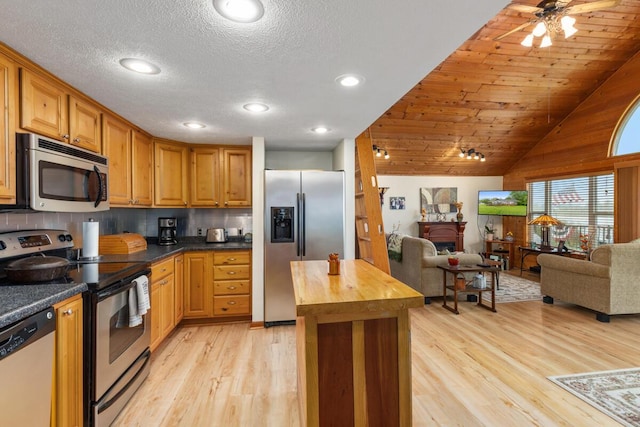 13341 Clausen Rd, Trufant, MI 49347 - kitchen with stainless steel appliances, open floor plan, wooden counters, light wood-style floors, and lofted ceiling