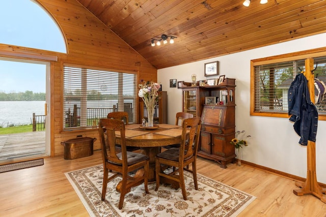 13341 Clausen Rd, Trufant, MI 49347 - dining area with wooden ceiling, light wood-style flooring, wood walls, high vaulted ceiling, and a water view