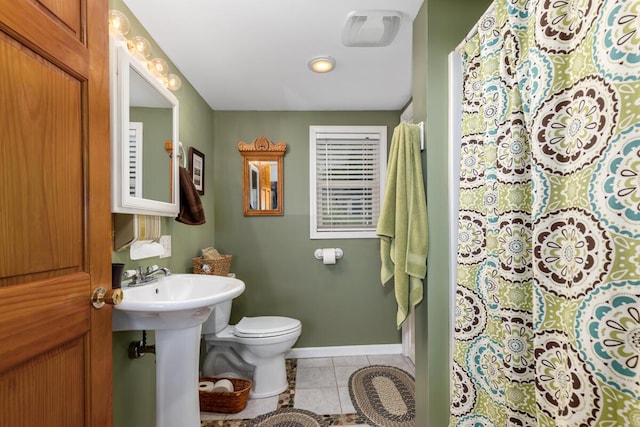 13341 Clausen Rd, Trufant, MI 49347 - bathroom featuring toilet, tile patterned floors, baseboards, and curtained shower