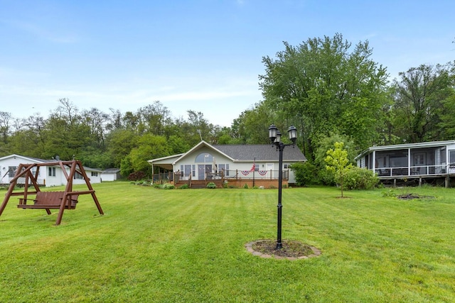 13341 Clausen Rd, Trufant, MI 49347 - view of grassy yard with a sunroom and view of scattered trees