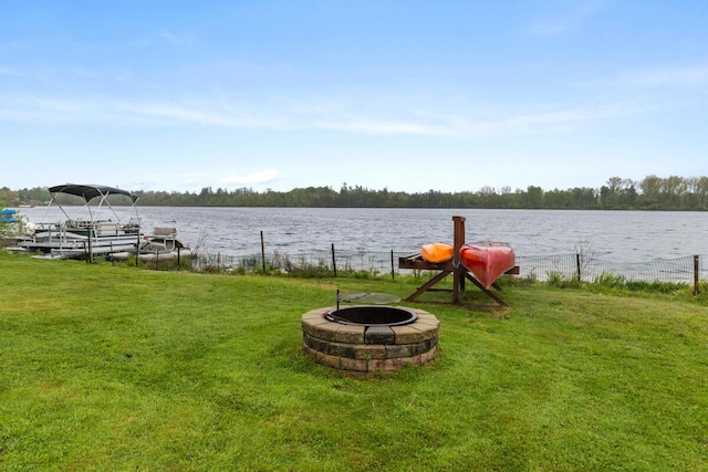 13341 Clausen Rd, Trufant, MI 49347 - view of grassy yard with an outdoor fire pit, a water view, and a dock