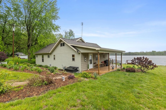 13341 Clausen Rd, Trufant, MI 49347 - rear view of house with a lawn and a water view