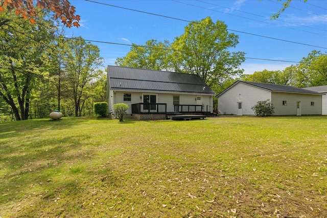 1710 215th Ave, Morley, MI 49336 - back of property featuring a deck, a yard, and metal roof