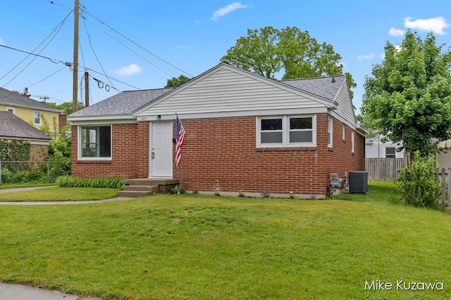 945 NW Dorothy St NW, Grand Rapids, MI 49504 - bungalow-style house featuring brick siding, a shingled roof, and central air condition unit