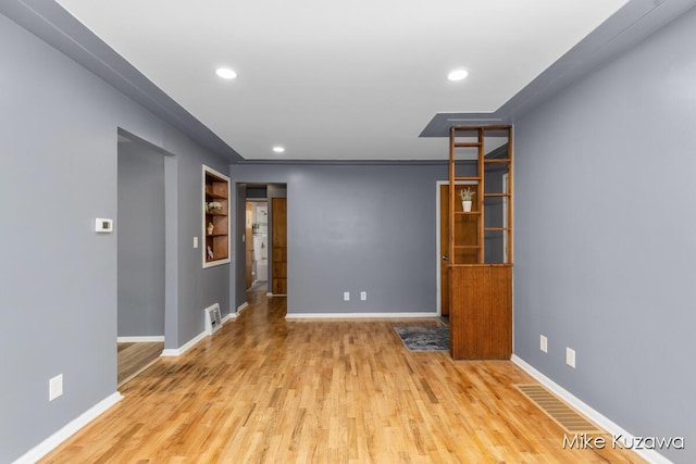 945 NW Dorothy St NW, Grand Rapids, MI 49504 - unfurnished room with wood finished floors, recessed lighting, baseboards, and built in features