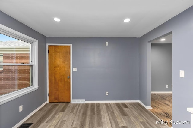 945 NW Dorothy St NW, Grand Rapids, MI 49504 - spare room with wood finished floors, baseboards, and recessed lighting