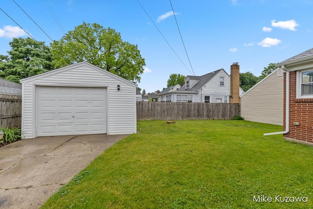 945 NW Dorothy St NW, Grand Rapids, MI 49504 - view of yard featuring a detached garage, an outdoor structure, and driveway