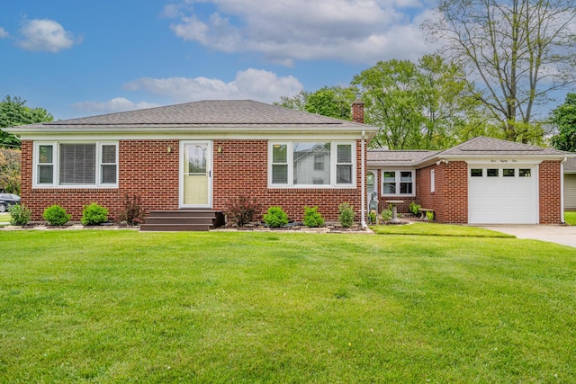 481 Gilson St, Coloma, MI 49038 - view of front of house with a chimney, brick siding, an attached garage, concrete driveway, and a front lawn