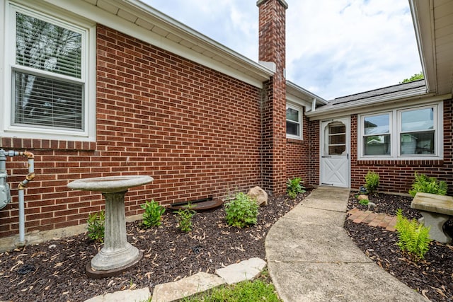 481 Gilson St, Coloma, MI 49038 - doorway to property with brick siding and a chimney
