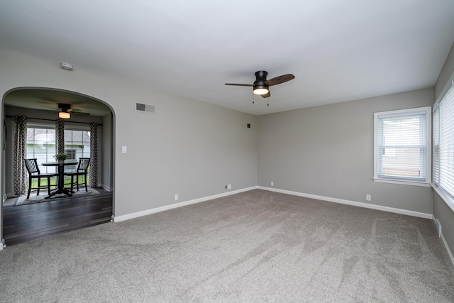 481 Gilson St, Coloma, MI 49038 - unfurnished room with a ceiling fan, dark colored carpet, arched walkways, and baseboards