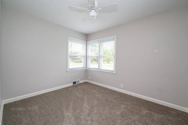 481 Gilson St, Coloma, MI 49038 - empty room with dark carpet, baseboards, and a ceiling fan