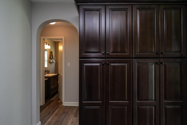 481 Gilson St, Coloma, MI 49038 - detailed view of arched walkways, wood finished floors, baseboards, and a sink