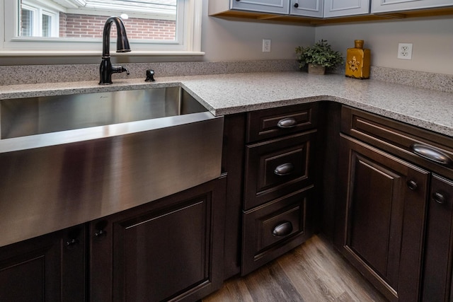 481 Gilson St, Coloma, MI 49038 - kitchen with wood finished floors, plenty of natural light, dark brown cabinetry, and a sink