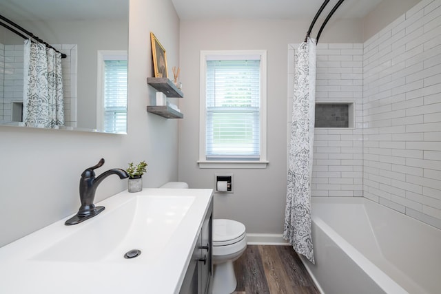 481 Gilson St, Coloma, MI 49038 - bathroom featuring toilet, wood finished floors, vanity, shower / tub combo, and baseboards