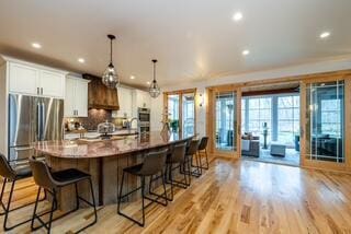 46306 Station Rd, New Buffalo, MI 49117 - kitchen with a kitchen bar, recessed lighting, plenty of natural light, a large island, and white cabinetry