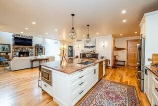 46306 Station Rd, New Buffalo, MI 49117 - kitchen featuring white cabinets, a sink, light wood-style flooring, stainless steel appliances, and recessed lighting