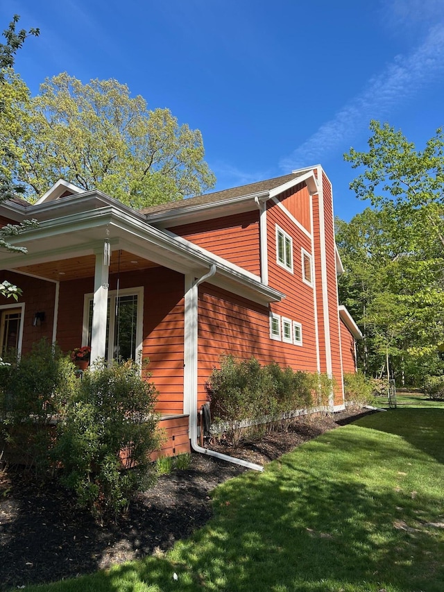 46306 Station Rd, New Buffalo, MI 49117 - view of side of home featuring a lawn and a chimney