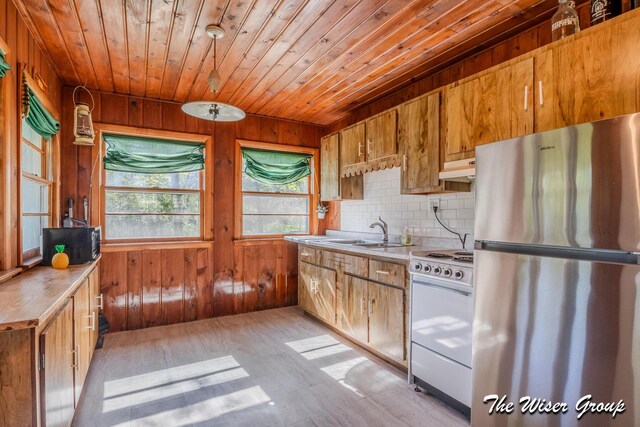 1261 W Channel St, Bitely, MI 49309 - kitchen featuring freestanding refrigerator, white range with electric stovetop, a sink, wooden walls, and wood ceiling