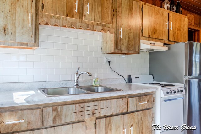 1261 W Channel St, Bitely, MI 49309 - kitchen with under cabinet range hood, white stove, a sink, light countertops, and backsplash