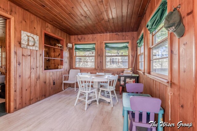 1261 W Channel St, Bitely, MI 49309 - dining area featuring wood walls, plenty of natural light, wooden ceiling, and wood finished floors