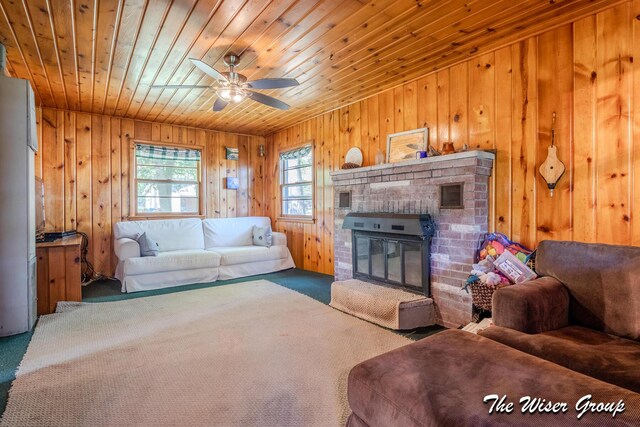 1261 W Channel St, Bitely, MI 49309 - living area featuring carpet, wood ceiling, wooden walls, a brick fireplace, and ceiling fan