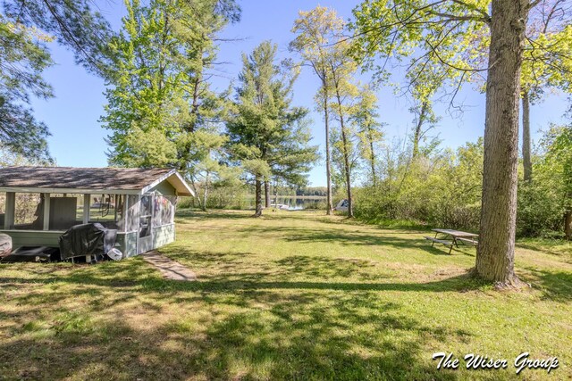 1261 W Channel St, Bitely, MI 49309 - view of grassy yard featuring a water view and an outdoor structure