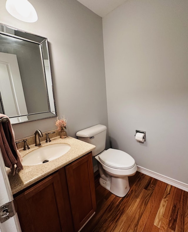 44750 Erin Dr, Plymouth, MI 48170 - half bathroom featuring vanity, toilet, wood finished floors, and baseboards
