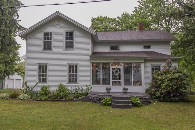 7610 W Kl Ave, Kalamazoo, MI 49009 - view of front of property featuring a sunroom, a chimney, a front lawn, and a shingled roof