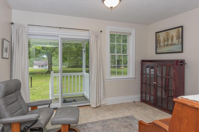 7610 W Kl Ave, Kalamazoo, MI 49009 - living area with baseboards and tile patterned flooring