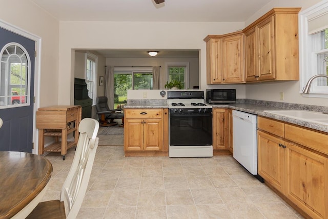 7610 W Kl Ave, Kalamazoo, MI 49009 - kitchen with dishwasher, gas stove, stainless steel microwave, a sink, and a peninsula