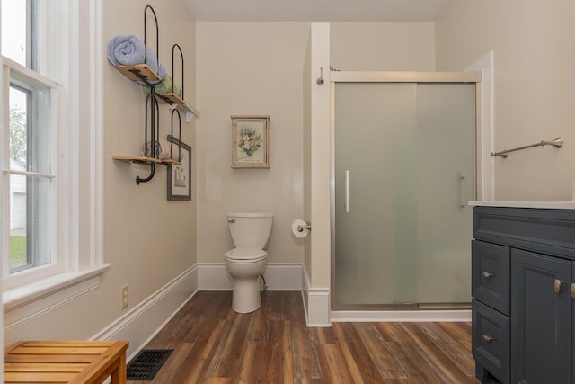 7610 W Kl Ave, Kalamazoo, MI 49009 - full bathroom with a shower stall, toilet, healthy amount of natural light, and wood finished floors