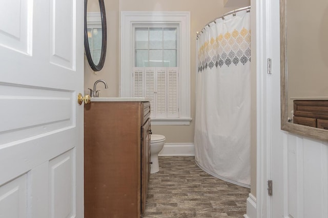 7610 W Kl Ave, Kalamazoo, MI 49009 - bathroom featuring toilet, vanity, baseboards, a shower with curtain, and wood finished floors