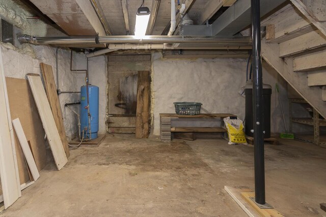 7610 W Kl Ave, Kalamazoo, MI 49009 - unfinished basement featuring a water pressure tank and stairway