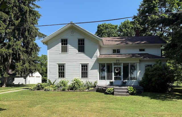 7610 W Kl Ave, Kalamazoo, MI 49009 - view of front facade with a front lawn, a chimney, a sunroom, and a shingled roof
