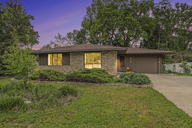 515 Springfield Cir, Niles, MI 49120 - view of front of house featuring concrete driveway, a garage, stone siding, board and batten siding, and a yard