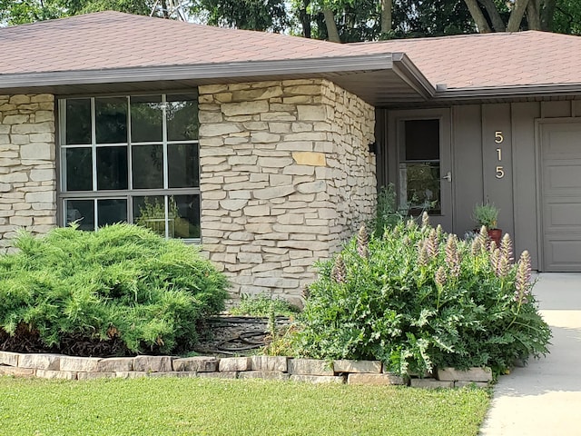 515 Springfield Cir, Niles, MI 49120 - view of exterior entry with stone siding, roof with shingles, and board and batten siding